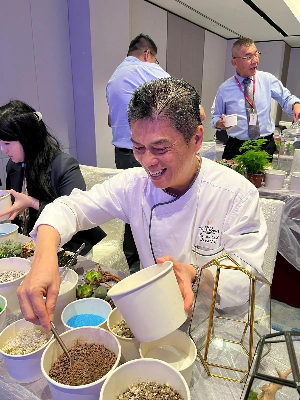 Executive Chef David Toh carefully assembling his terrarium, demonstrating the hotel's hands-on approach to sustainability