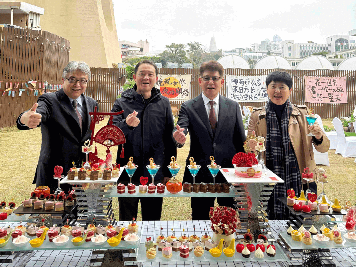 Senior leadership captures a moment at the dessert table, which featured an exquisite display of sweet treats.