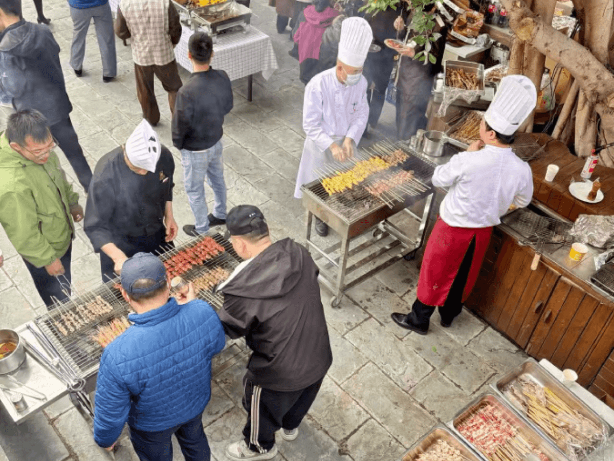 Chefs demonstrate their culinary craft for the staff, providing a premium barbecue experience.