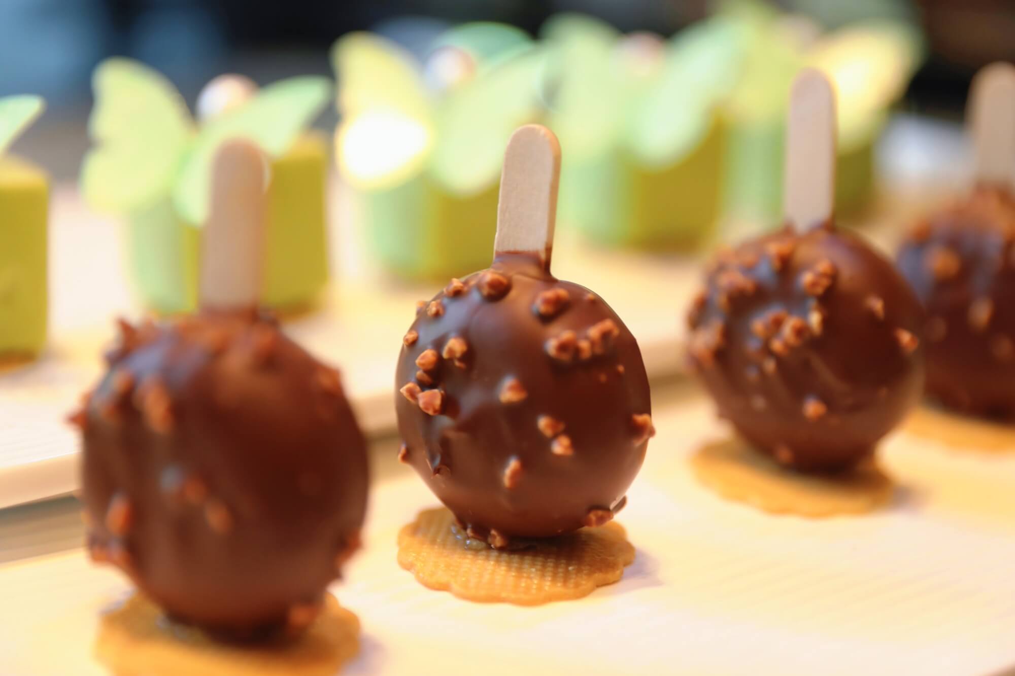 The Crispy Dream Dragon Devil Cake, chocolate-coated and served on sticks.