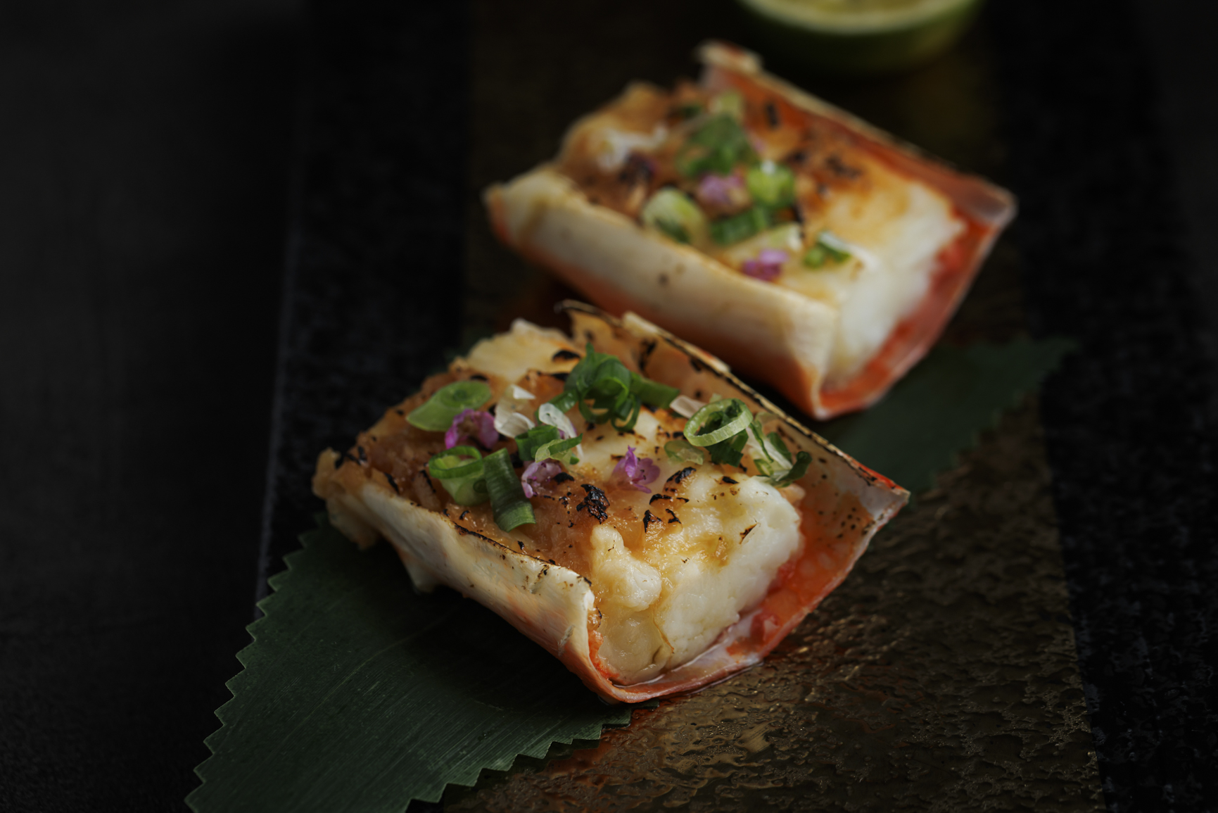 Grilled Hokkaido king crab legs, gratinated in the shell with Exotica Umami butter.