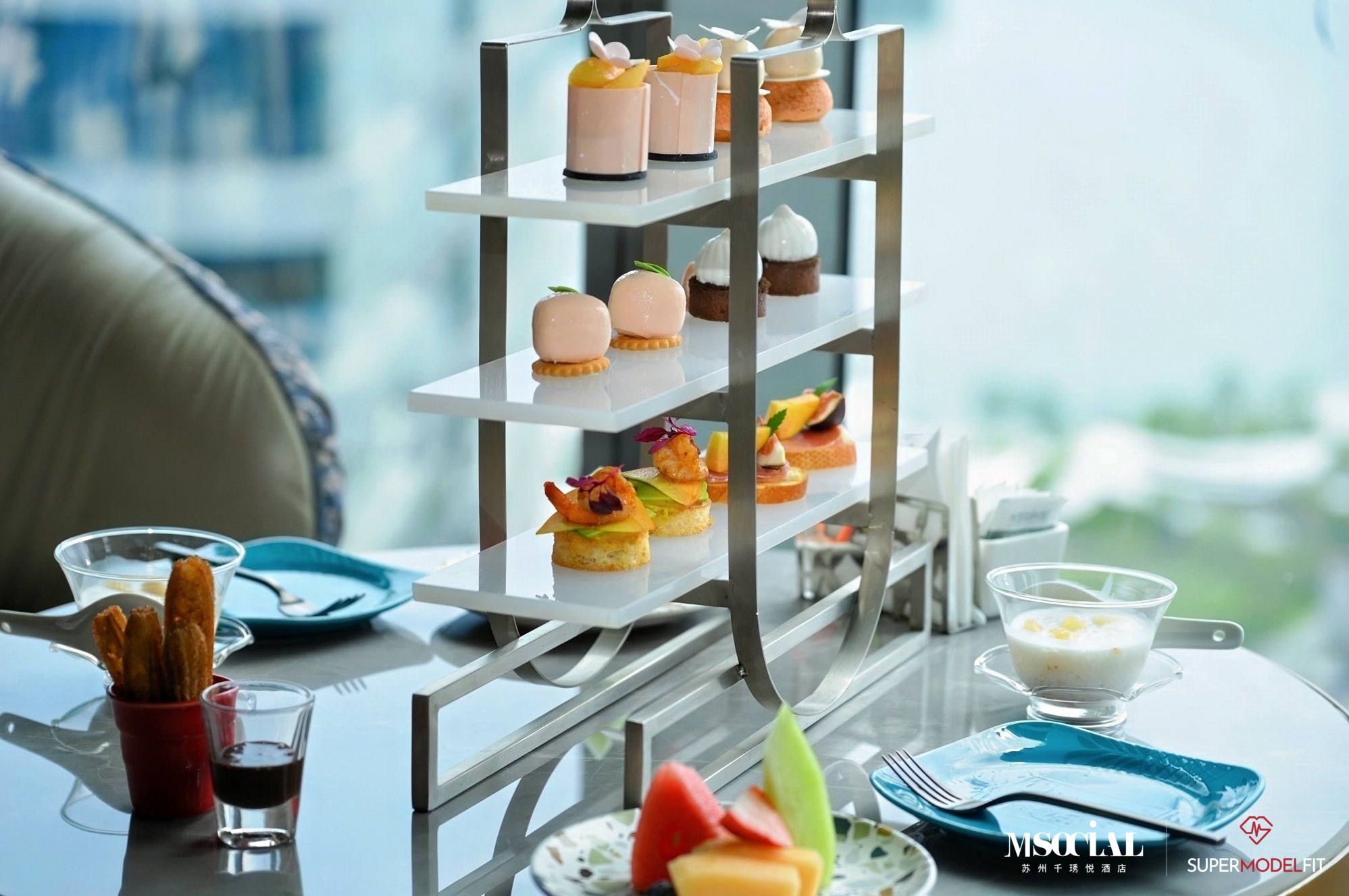 Pastries, churros and chilled fruit on the afternoon tea stand.