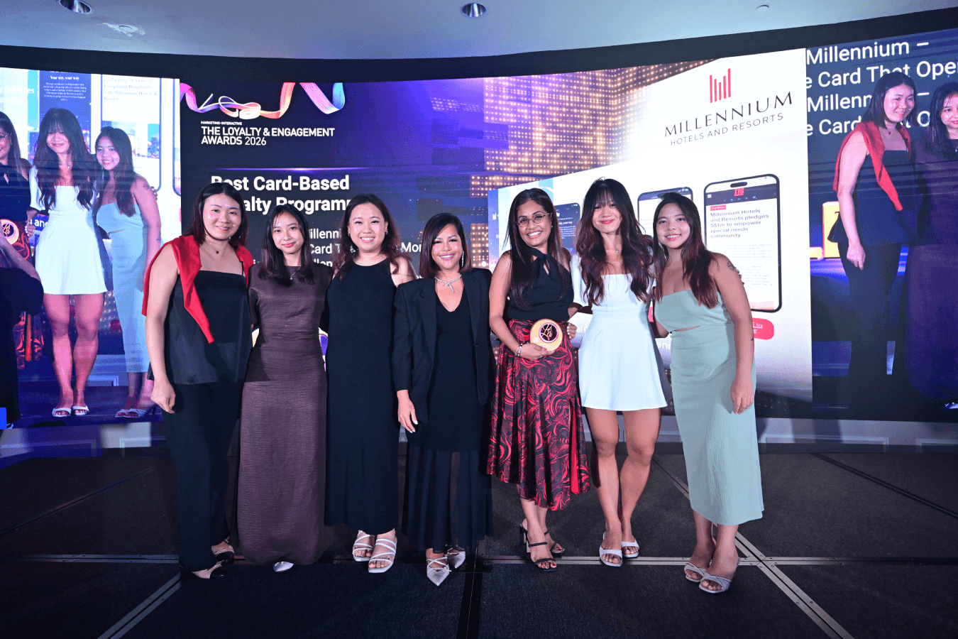 The team collects gold for Best Card-based Loyalty Programme at The Fullerton Hotel Singapore.