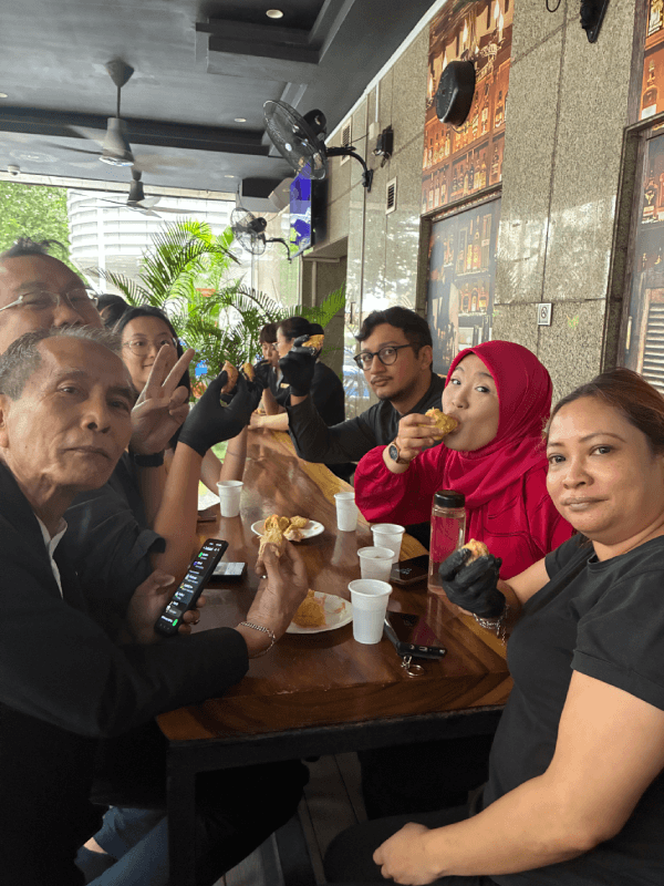 Team members gather around the table at M Bar for the durian feast.