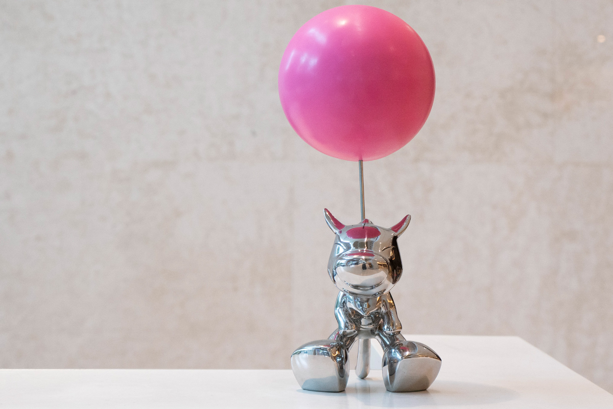 Go Up, a mirror-finished figure lifted by a single balloon.