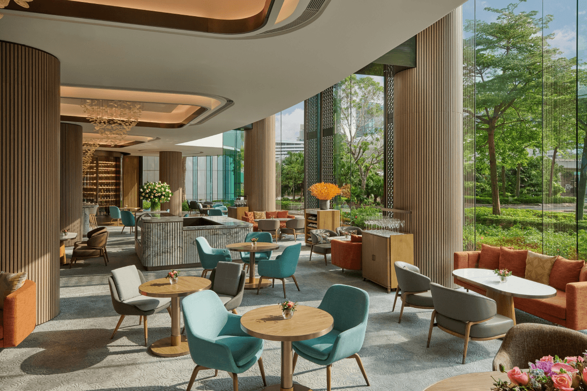 The Lounge by day, with garden views and soft seating for a long afternoon.
