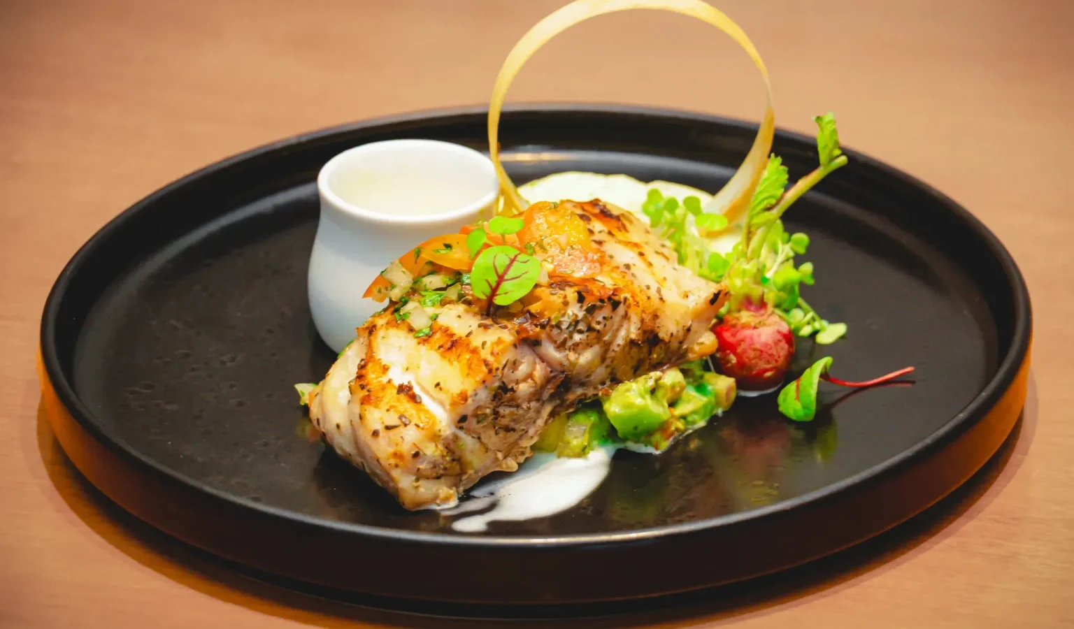 Ocean-Kissed Snapper: a harmonious blend of fresh snapper, sweet fruits, crisp vegetables, and house-crafted sauce