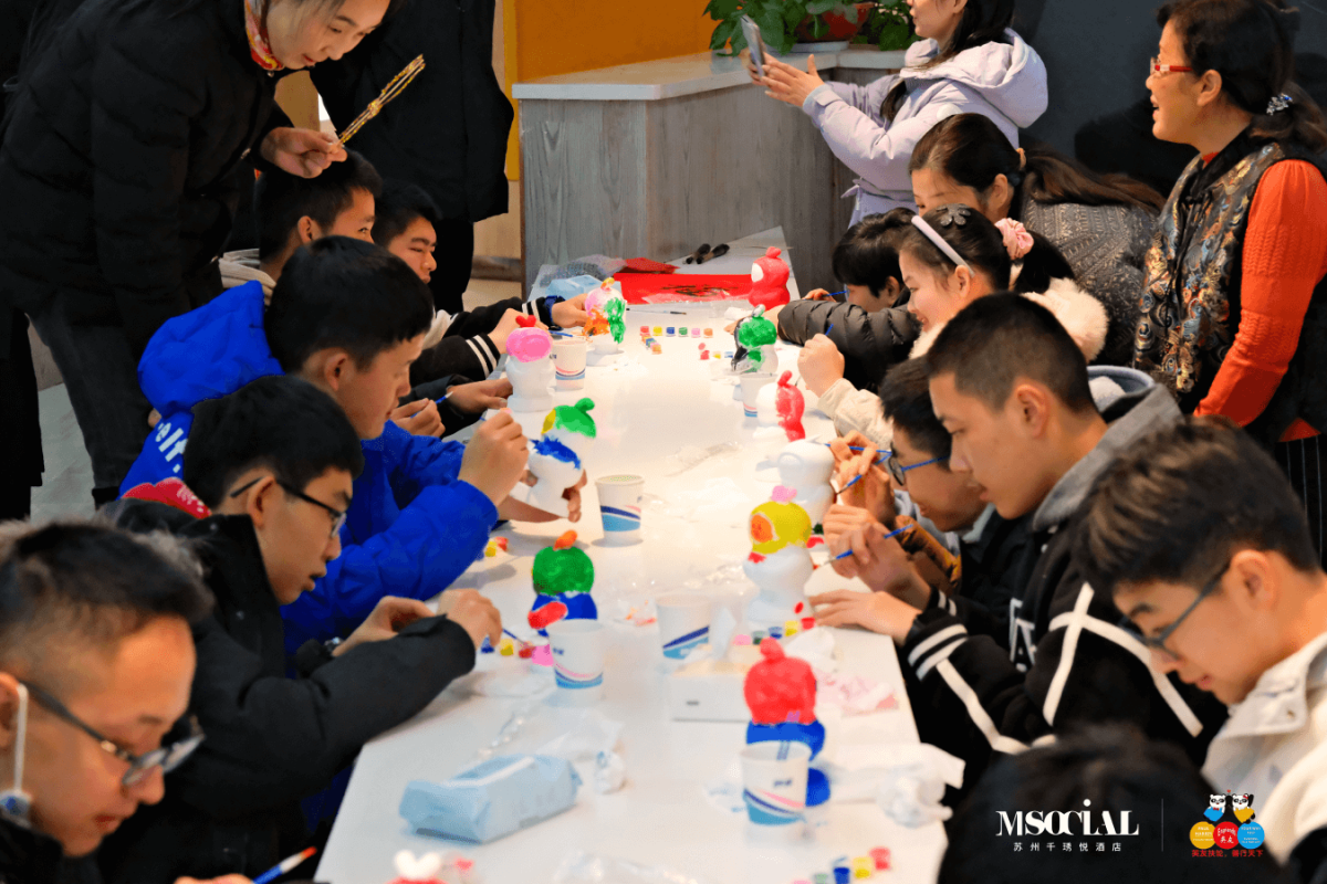 Children engaged in hands-on art activities, creating colourful crafts under the guidance of staff volunteers