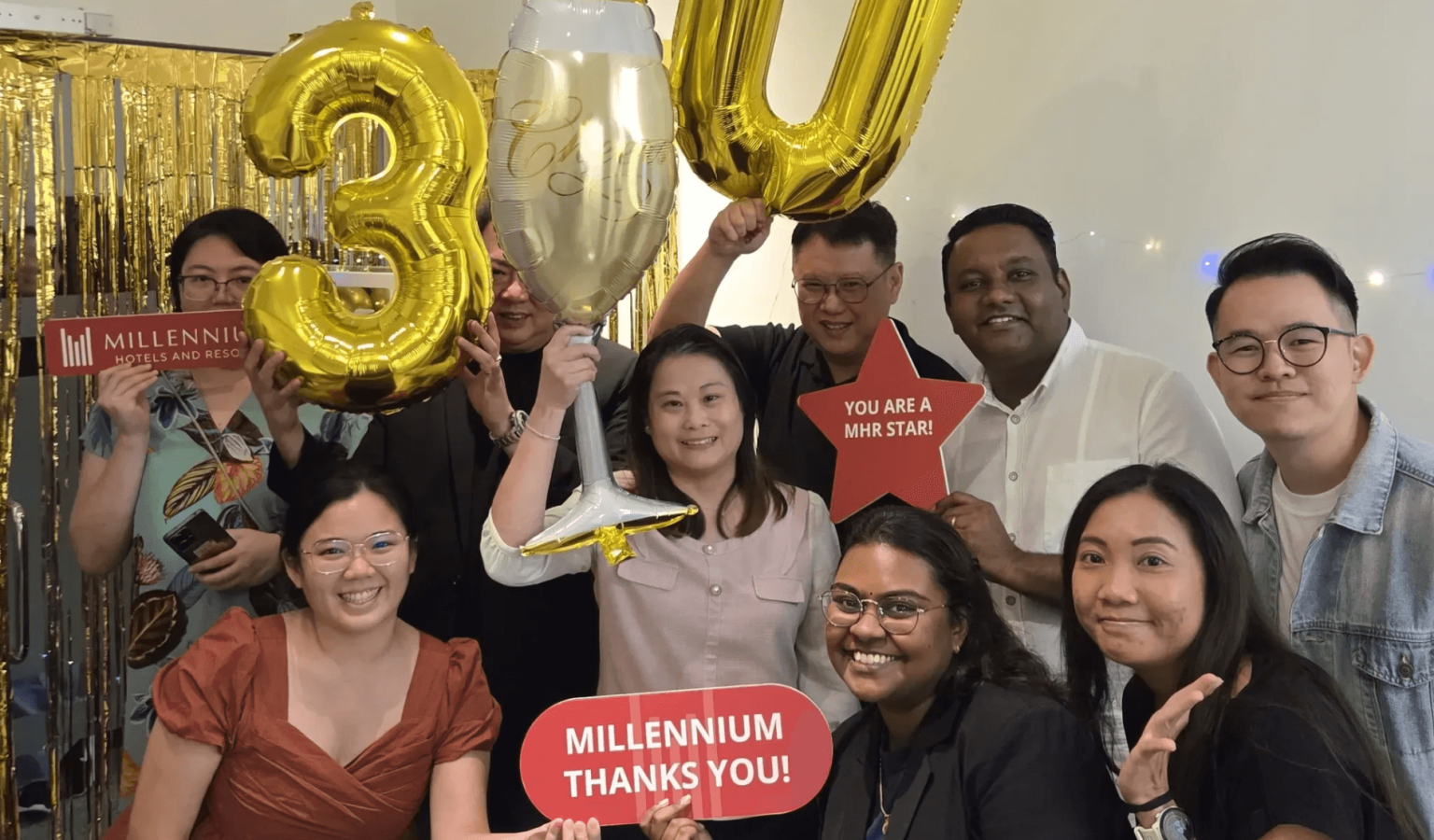 All employees gathering for a celebratory group picture marking Millennium Hotels and Resorts' 30 years