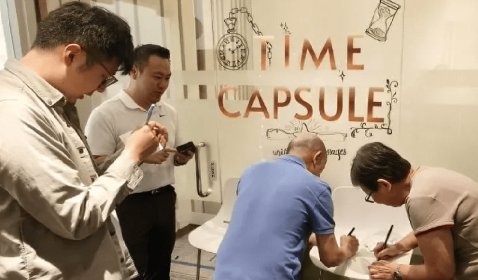 Team members writing heartfelt messages for the Time Capsule: Letters to the Future