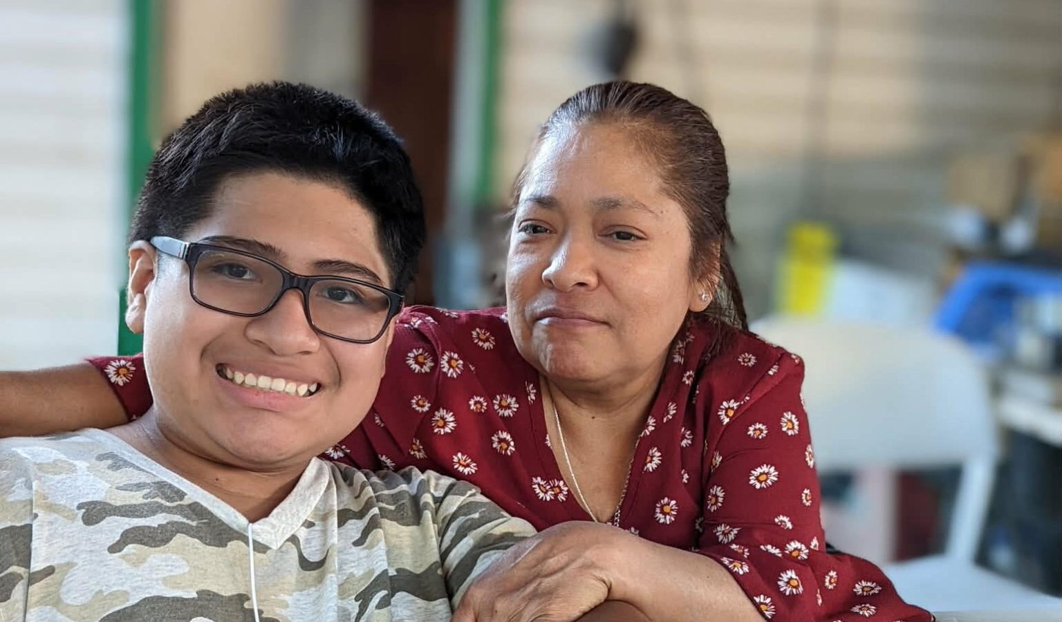 Sara with her grandson Adrian, now 18, sharing a quiet moment away from the hotel floors she has walked for a quarter of a century.