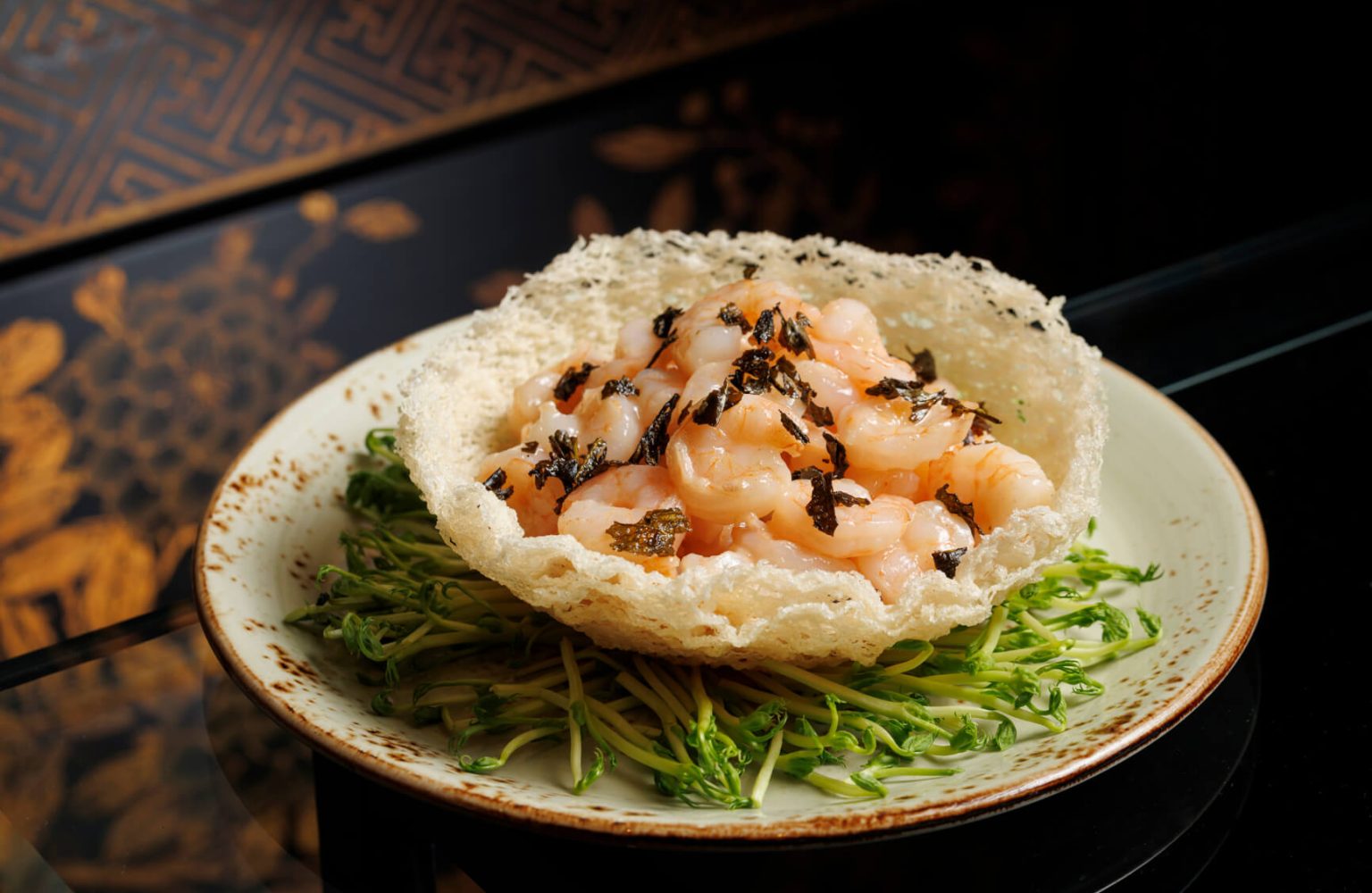Delicate river shrimps, wok-tossed with the grassy warmth of Long Jing tea and served in a crisp rice basket.