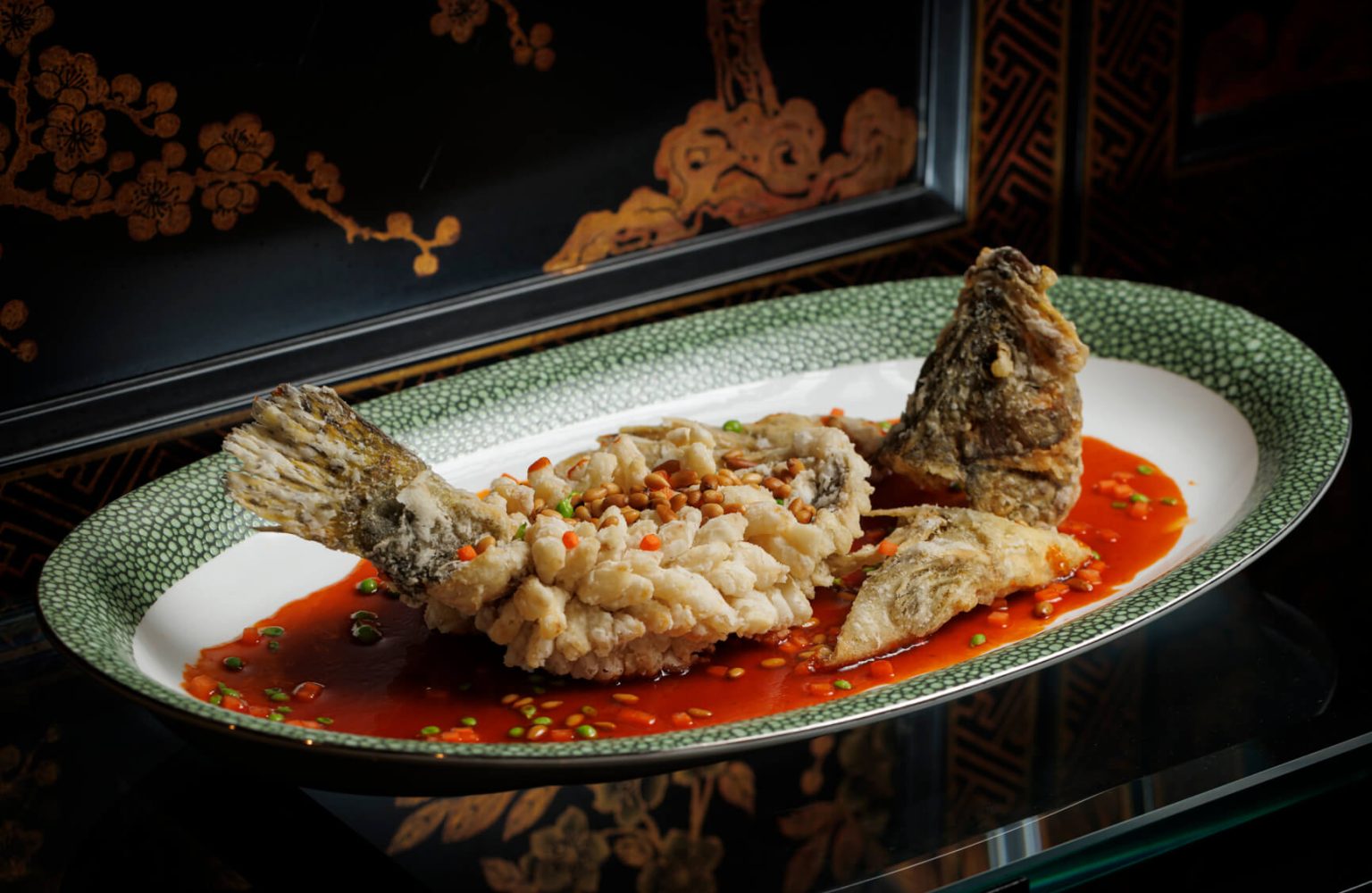 Deep-fried Mandarin Fish with Pine Nuts and Sweet and Sour Sauce at Tao Li, where crisp-fried fish meets slightly sour preserved vegetables, crunchy pine nuts, and a sweet and sour dressing.