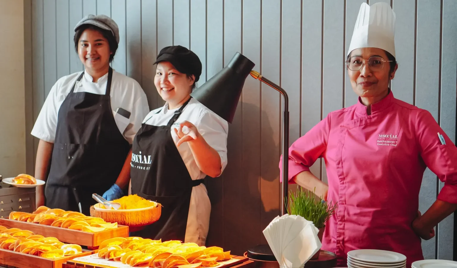 The culinary team stands ready behind the counter to serve authentic Thai delights, welcoming new buddies with local flavours
