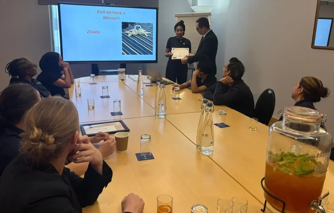 Hotel General Manager Sachin Rana presenting the winner with a certificate and £20 gift voucher